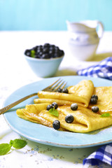 Thin pancakes with blackberry and honey.