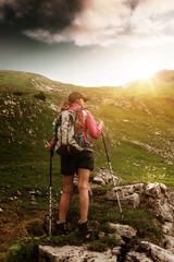 Woman trekking in the Alps with a backpack