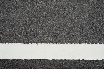 Fototapeta premium Asphalt road with white dividing stripes.