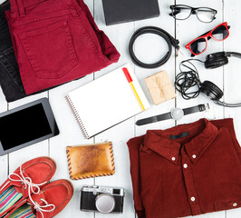 Travel concept - notepad, tablet pc, clothes, headphones, camera
