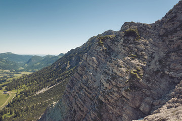 Fototapeta na wymiar View from above on rocky cliffs near Alps