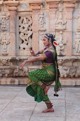 Fototapeta na wymiar kuchipudi is one of the classical dance forms of india,belongs to state andhra pradesh.here the dancer poses before a temple