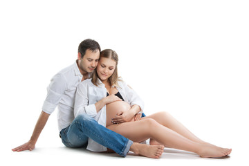 Beautiful young couple expecting baby. A happy family. Isolation on a white background. Pregnancy, childbirth.