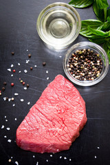 beef steak with spices and seasonings. a big piece of meat