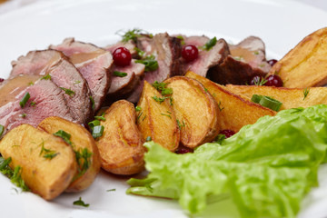 Tasty roasted pork meat with potatoes