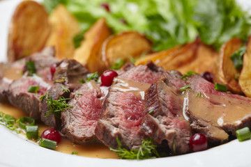 Tasty roasted pork meat with potatoes