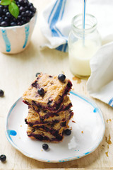 Blueberry cake and bottle of milk .