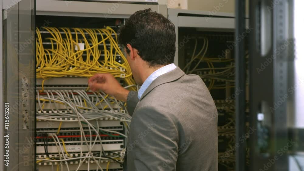 Poster Technician looking at open server locker