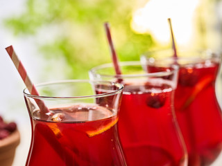 On wooden boards is ice cold beverage glass with red raspberry lemon cocktail . Part of alcohol country cocktail beverage number hundred thirty four with mint. Group cocktails on outdoor.