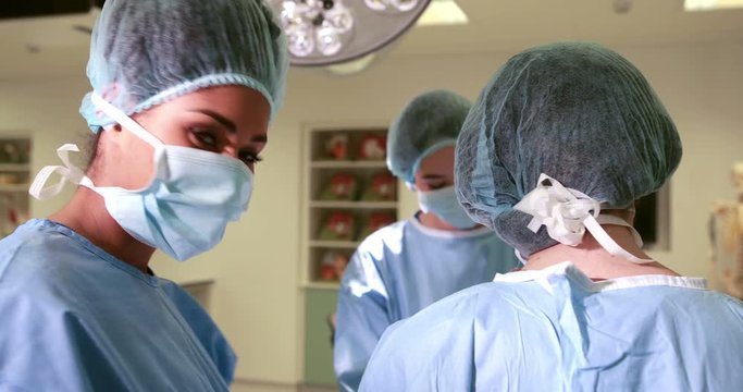 Surgical team working together in operating theater in high quality 4k format