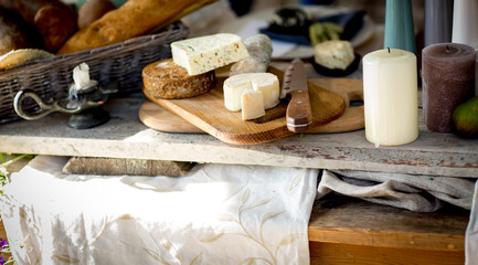 various French cheese on a wooden board