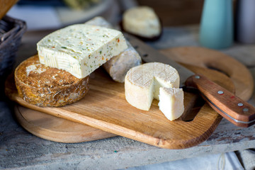 various French cheese on a wooden board