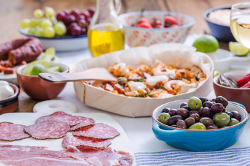 fresh olives and paella in background