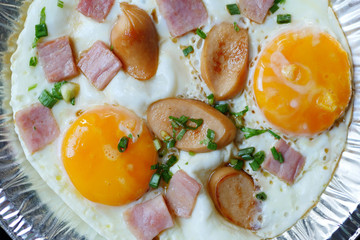 pan egg with ham and sausages