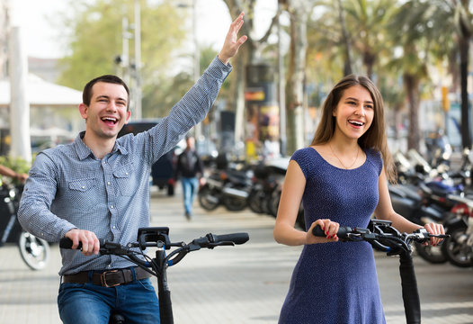 Young couple on electric bikes .