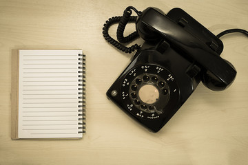 old telephone with blank notepad