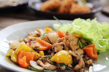 Stir fry chicken with black pepper on wood background