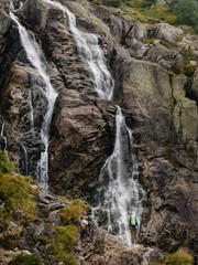 Fototapeta na wymiar Woman near Siklawa waterfall in Tatra mountains