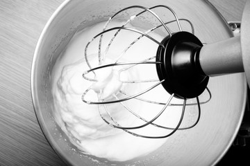 The process of whipping egg whites in a planetary mixer. Selecti