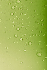 Drops of water on a color background. Green. Toned