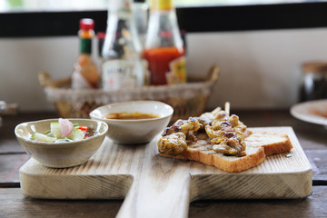 Malaysian food chicken satay with peanut sauce on wood backgroun