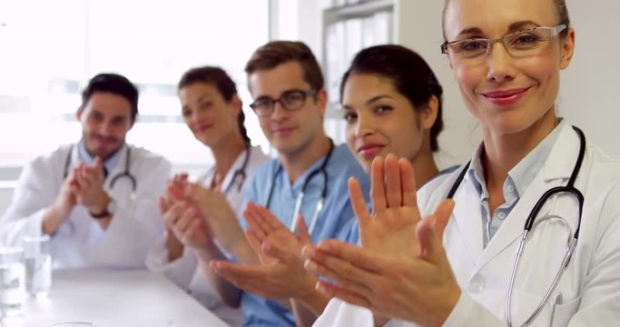 Medical team clapping at camera