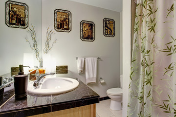 Bathroom interior with wooden cabinet and granite counter top