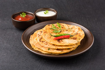Traditional Indian bread-Aloo paratha ,potato stuffed bread. served with tomato ketchup or sauce and curd