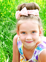 Adorable smiling little girl on the meadow