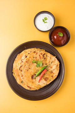Traditional Indian bread-Aloo paratha ,potato stuffed bread. served with tomato ketchup or sauce and curd