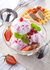 Ice Cream with Strawberry, Mint and waffles. Homemade product. On the wooden table.