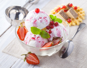 Ice Cream with Strawberry, Mint and waffles. Homemade product. On the wooden table.