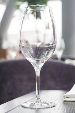 Wine glass on a wooden table in a restaurant