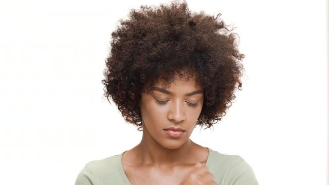 Upset young beautiful african girl over white background.