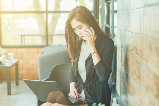 Asian business women using notebook and Businessmen and women ar