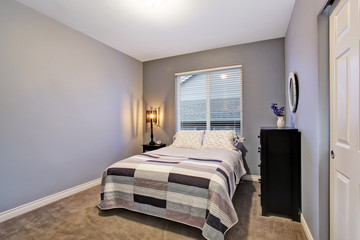 Gray simple bedroom with big bed, large window.