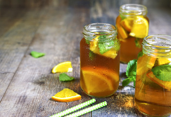 Orange iced tea in a glass jar.