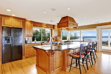 Luxury kitchen with water view, island and sink.