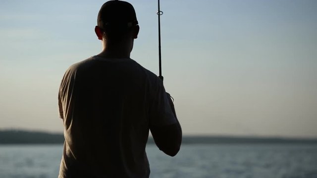 man fishing at sunrise