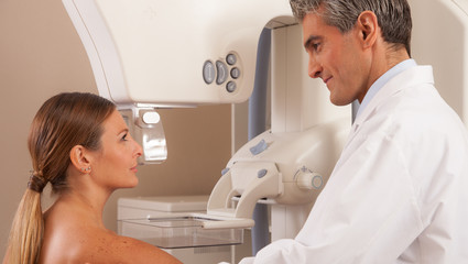 Young male doctor reassuring woman before mammography scan