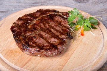 Prepared beef steak on a wooden board