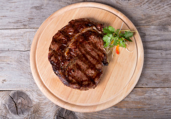 Prepared beef steak on a wooden board