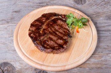 Prepared beef steak on a wooden board
