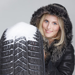 Woman with winter tyre