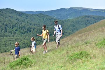 Family of four hiking in the mountain
