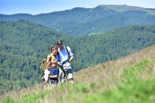Family on a hiking day looking at map