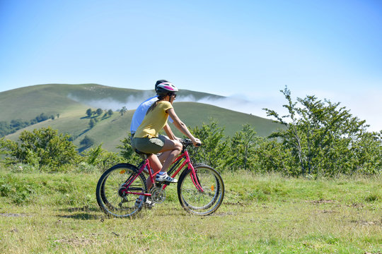 Couple riding bikes in the pyrenees