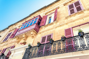 Fototapeta premium Balconies and windows with shutters in Mdina, Malta