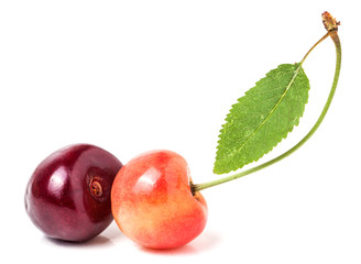 Two cherries with leaf closeup isolated on white background