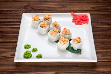 Delicious Sushi rolls served on a wooden plate
